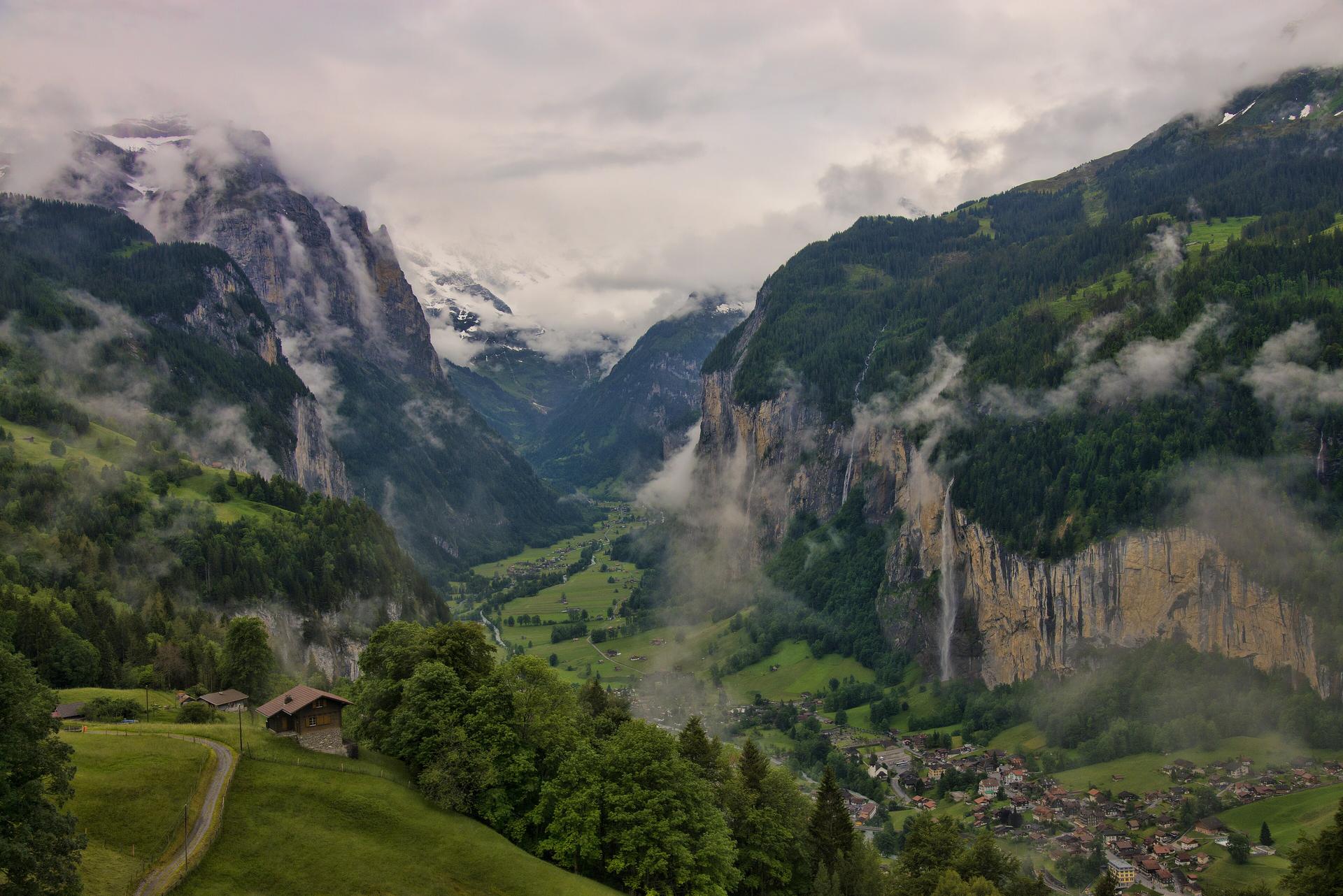 Alpine valley with waterfalls and mountain villages in the Swiss Alps